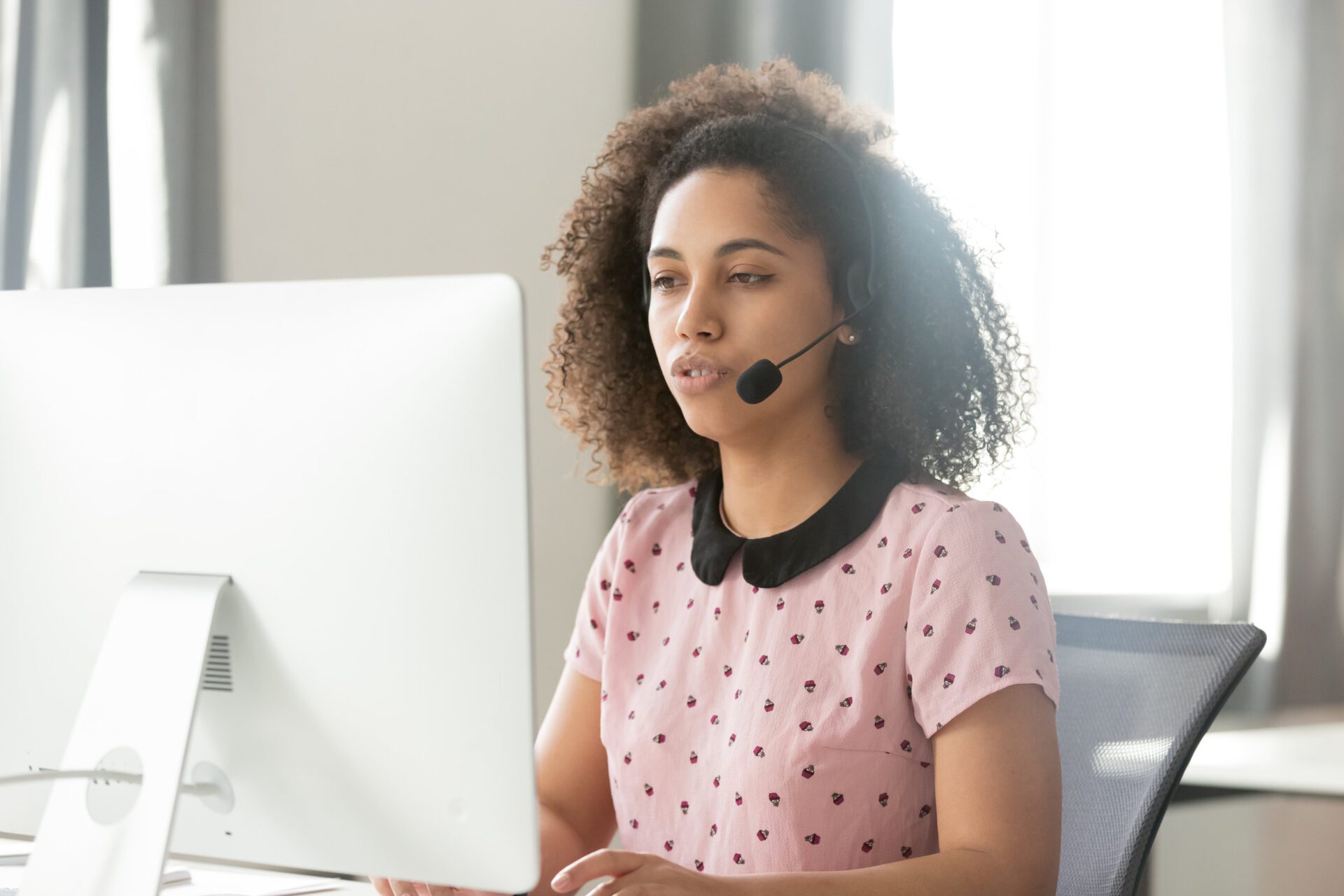 Call center operator in wireless headset talking using computer customer portal